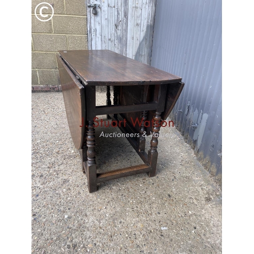 54 - An antique oak gate leg table 127cm wide