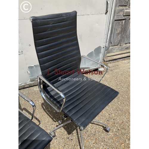 73 - A pair of eames style black leather and chrome office chairs