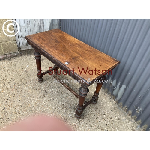 76 - An ornate mahogany hall table with two drawers 108wide