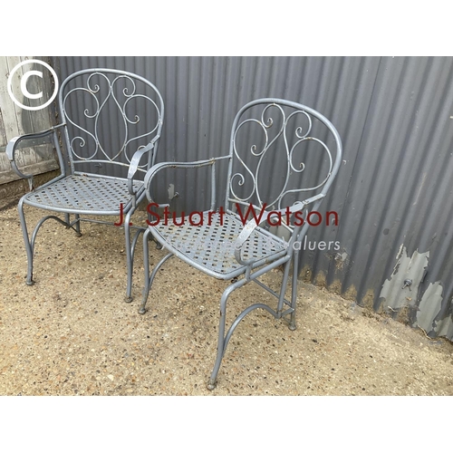 78 - A pair of ornate metal folding garden chairsn