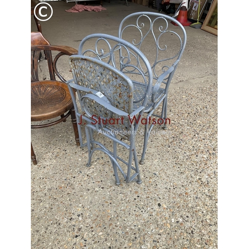 78 - A pair of ornate metal folding garden chairsn