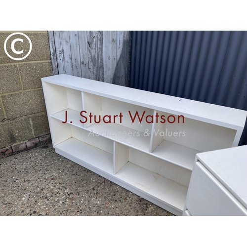 8 - A painted ply chest of three together with a painted open fronted bookcase