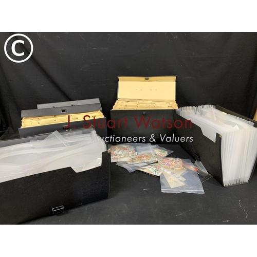 953 - Four black filing cases all with bags  of used foreign stamps