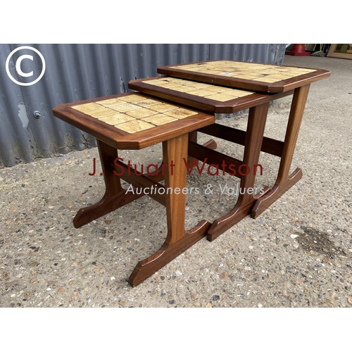 96 - A Nathan teak nest of three occasional tables with tiled top