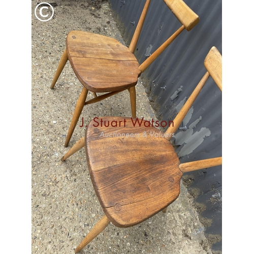 99 - A pair of ercol stacker chairs