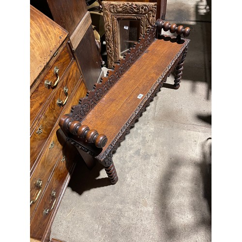 281 - A carved oak window seat 122cm wide