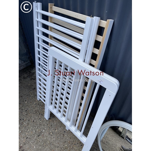332 - A modern white painted  cot by John Lewis together with white wall mirror