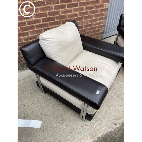 339 - A pair of Italian style (natuzzi or similar) brown and cream leather armchairs in chrome bases