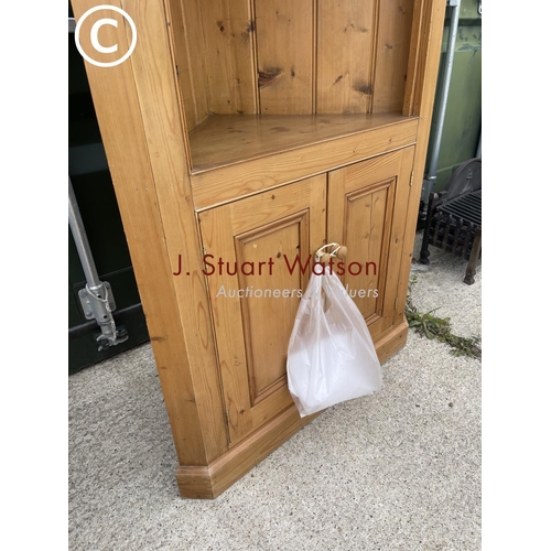 350B - A large country pine corner cupboard with open front over cupboard doors