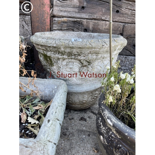 490D - A large circular concrete planter together with two other smaller pots