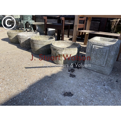 490E - A set of four circular concrete planters together with a square rose pattern planter