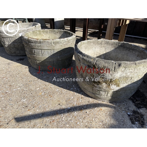 490E - A set of four circular concrete planters together with a square rose pattern planter