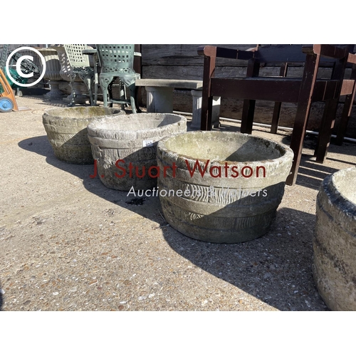 490E - A set of four circular concrete planters together with a square rose pattern planter