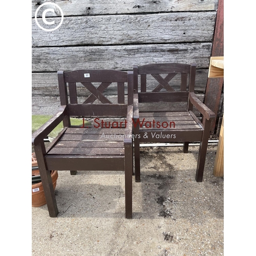 490L - A pair of wooden carver garden chairs