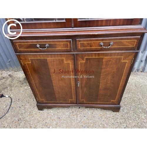 107 - A reproduction mahogany bookcase cupboard