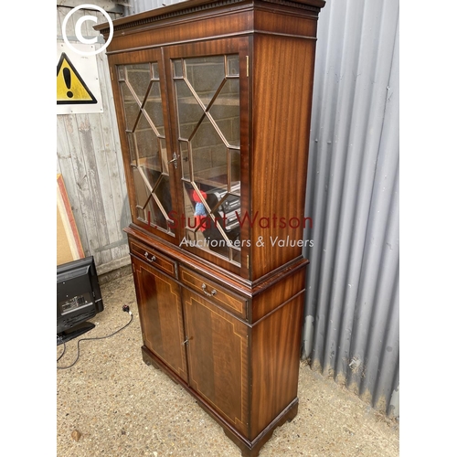 107 - A reproduction mahogany bookcase cupboard