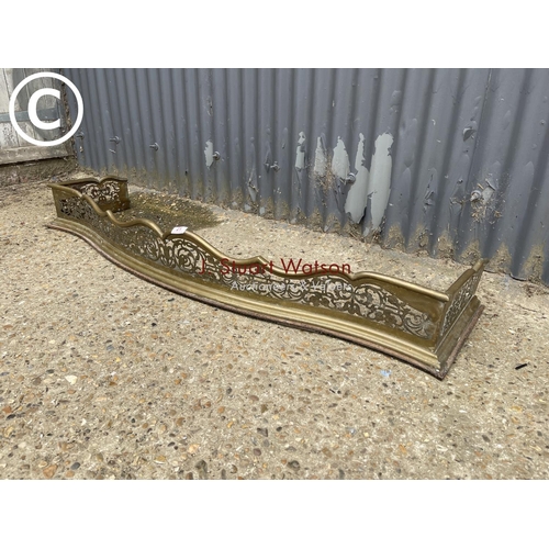 21 - An ornate brass fire guard