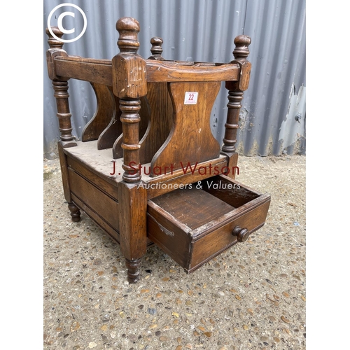 22 - A reproduction oak Canterbury style book rack with drawer