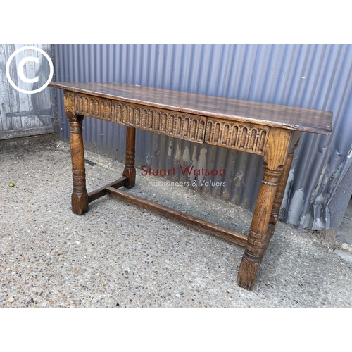 246 - An antique oak stretcher table with drawer
