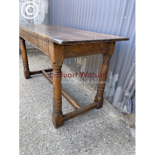 246 - An antique oak stretcher table with drawer