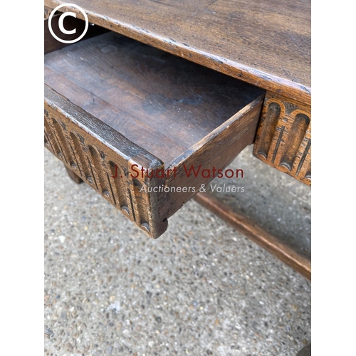246 - An antique oak stretcher table with drawer
