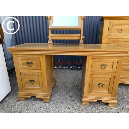 249 - A good quality American light oak bedroom pair consisting of tallboy chest and a dressing table with... 