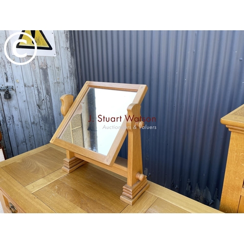 249 - A good quality American light oak bedroom pair consisting of tallboy chest and a dressing table with... 