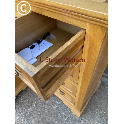 249 - A good quality American light oak bedroom pair consisting of tallboy chest and a dressing table with... 