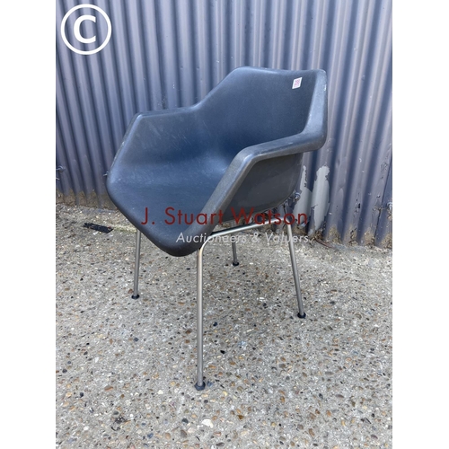 255 - A mid century black tub chair in chrome base labelled HILLE BY ROBIN DAY