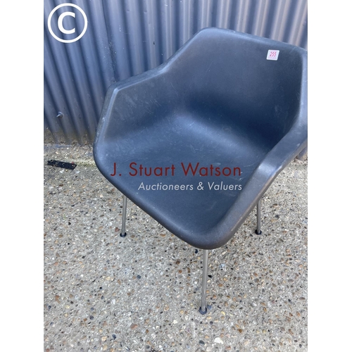 255 - A mid century black tub chair in chrome base labelled HILLE BY ROBIN DAY