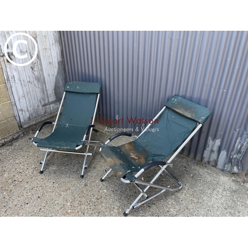264 - A pair of green folding garden lounger chairs