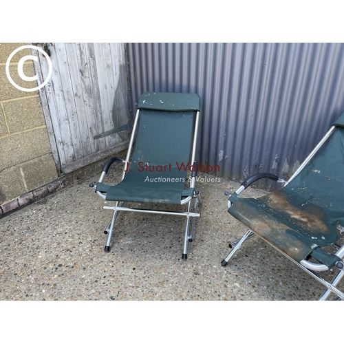264 - A pair of green folding garden lounger chairs