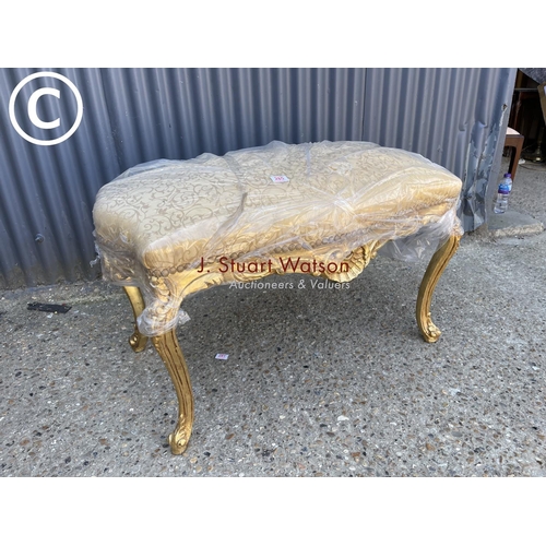 285 - A large gold gilt footstool / window seat with gold upholstered top