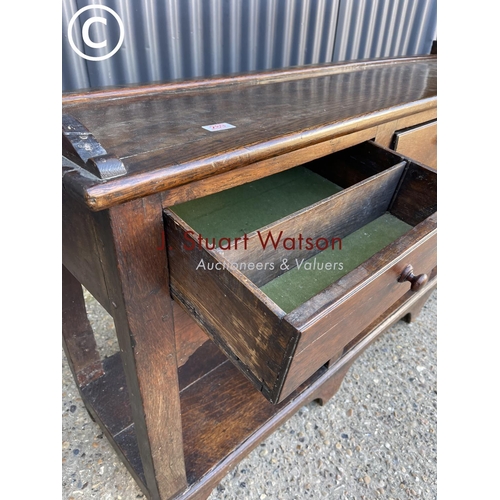 289 - An antique oak three drawer dresser base with later farmhouse style pine plate rack top 154cm wide