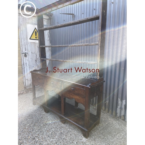 289 - An antique oak three drawer dresser base with later farmhouse style pine plate rack top 154cm wide
