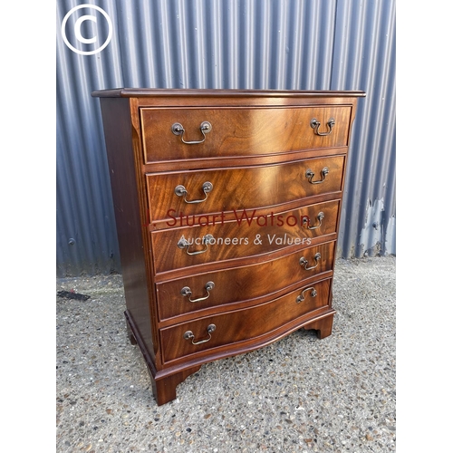 291 - A reproduction mahogany serpentine front chest of five drawers