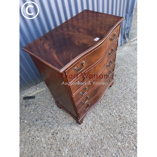 291 - A reproduction mahogany serpentine front chest of five drawers