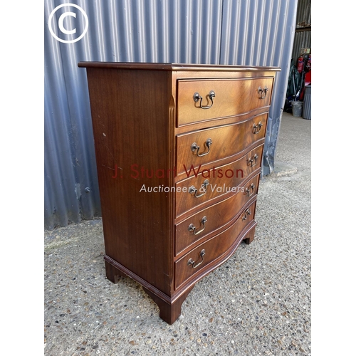 291 - A reproduction mahogany serpentine front chest of five drawers