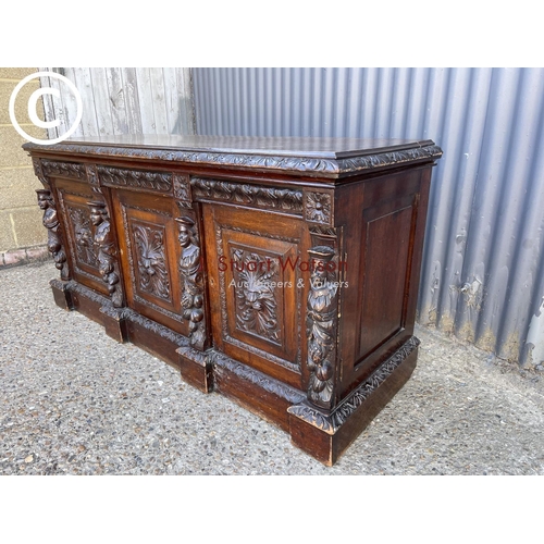 299 - A carved oak three door sideboard 150 x50x70