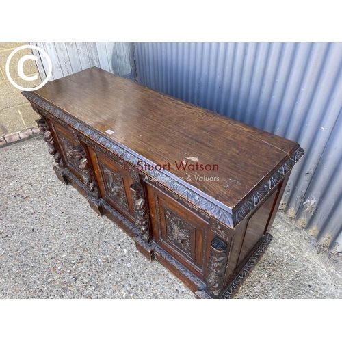 299 - A carved oak three door sideboard 150 x50x70