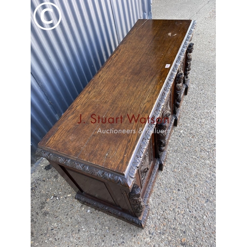 299 - A carved oak three door sideboard 150 x50x70