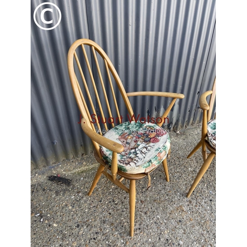 315 - A pair of mid century light elm Ercol carver chairs