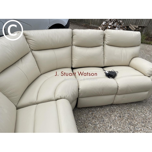 47 - A modern cream leather effect corner sofa with electric recline and foot rest function.