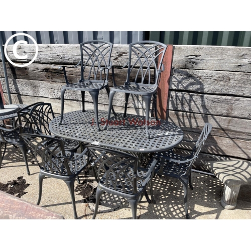 472 - An oval aluminium garden table with six chairs