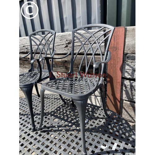 472 - An oval aluminium garden table with six chairs