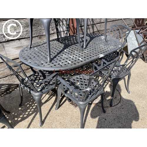 472 - An oval aluminium garden table with six chairs