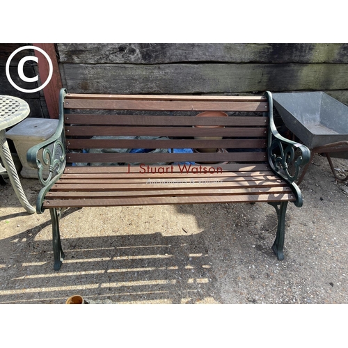474 - A green painted iron framed garden bench with hardwood seat