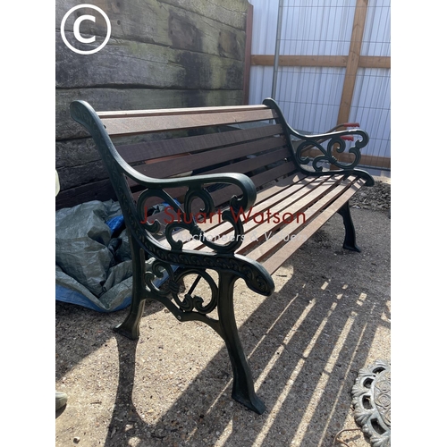 474 - A green painted iron framed garden bench with hardwood seat