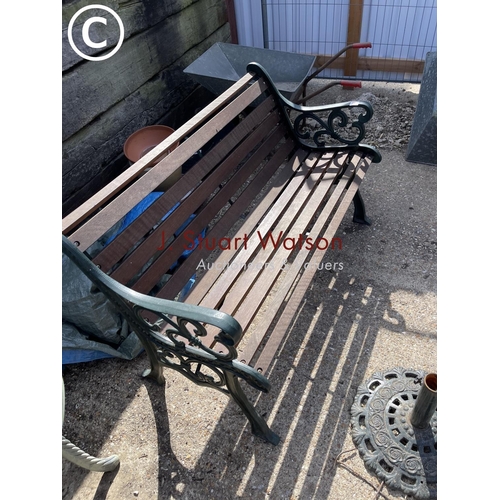 474 - A green painted iron framed garden bench with hardwood seat