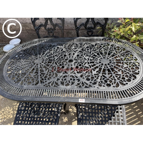 475 - A black painted ornate aluminium garden table with four matching chairs